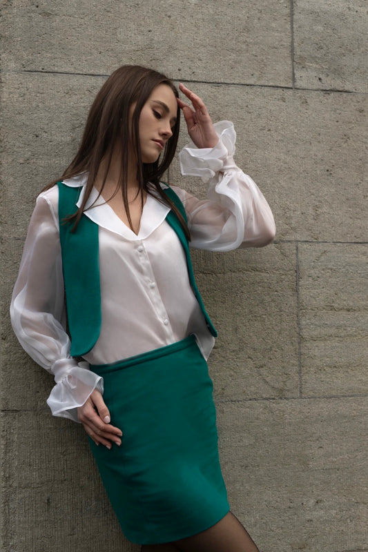 Business women in green set vest and skirt by Lola Tong. 